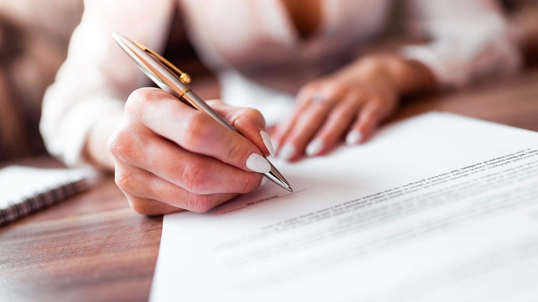 business-woman-signing-a-contract-2210x1473-2 bankruptcy