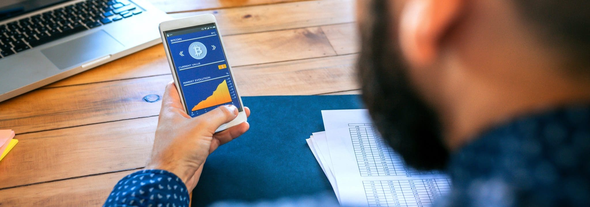 Businessman looking mobile with bitcoins information crypto assests